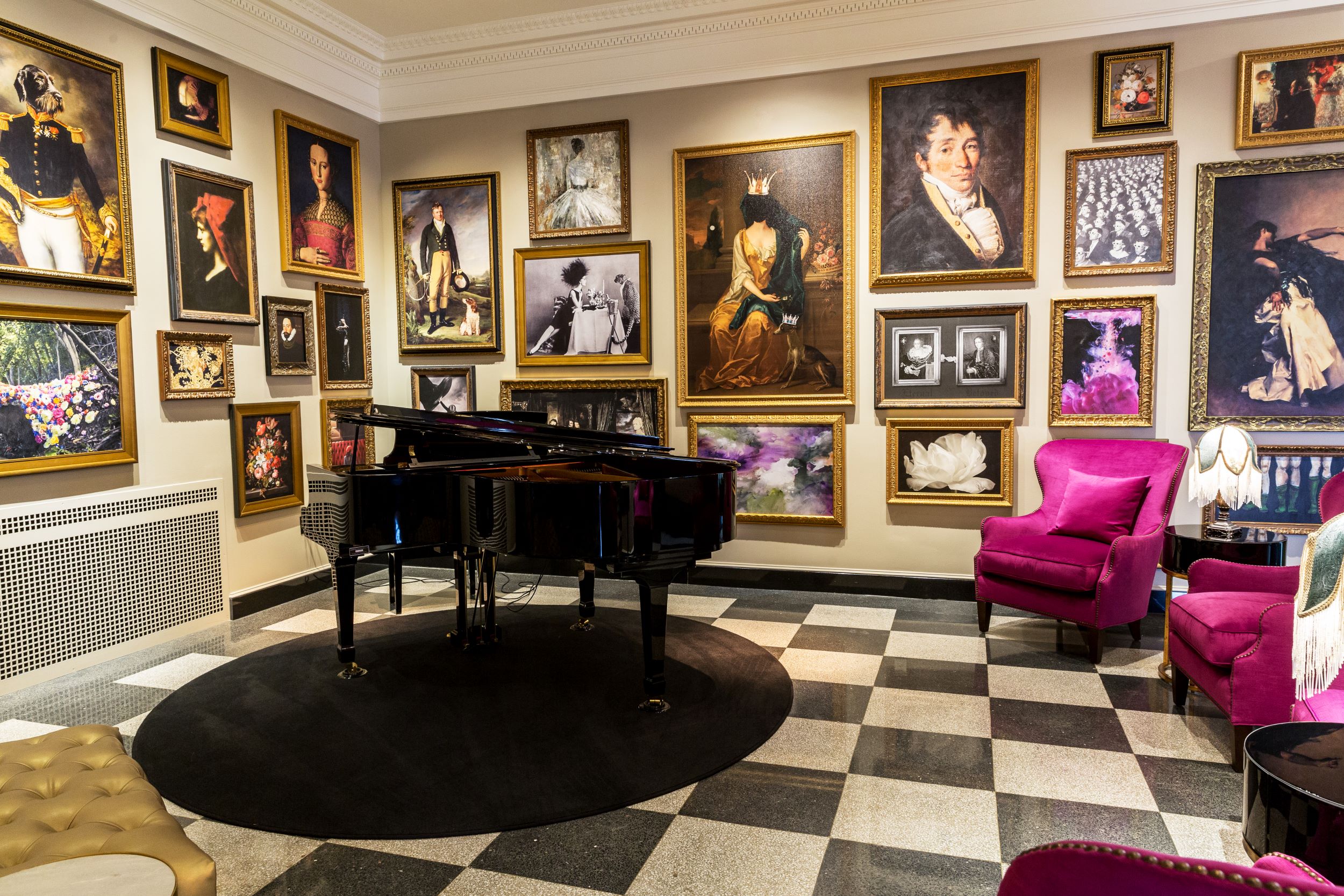The Raleigh Room with piano, bright purple armchairs, and historic-themed portraits on the walls