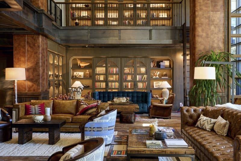 Sophisticated library seating area with book-filled shelves and leather sofas