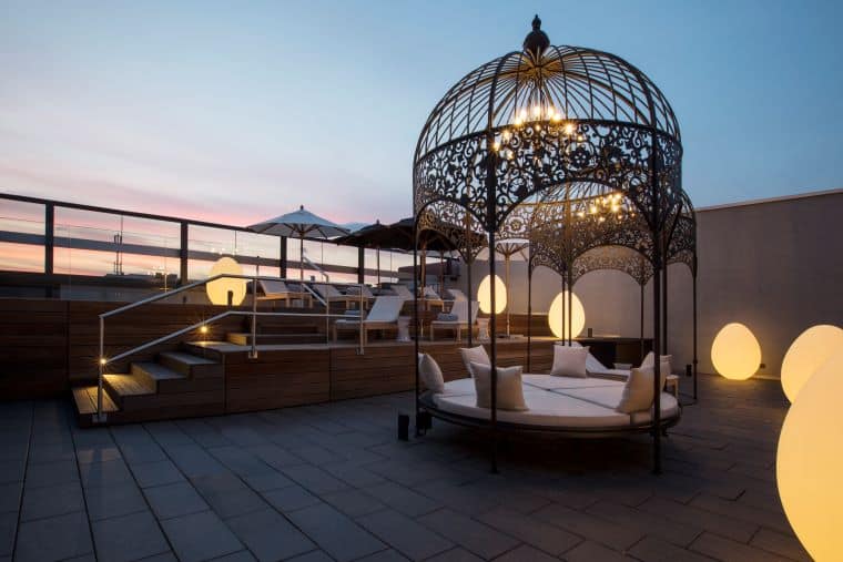 6th floor rooftop spa terrace at dusk with gazebo-style seating, egg-shaped lighting