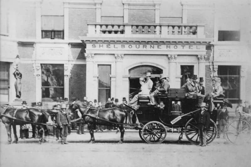 Black and white image of horse drawn carriage in front of historic Shelbourne Hotel